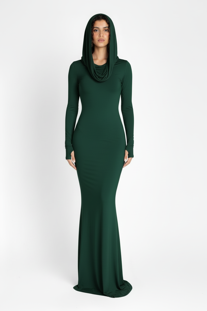 Woman wearing a long green dress with a hood on a white background
