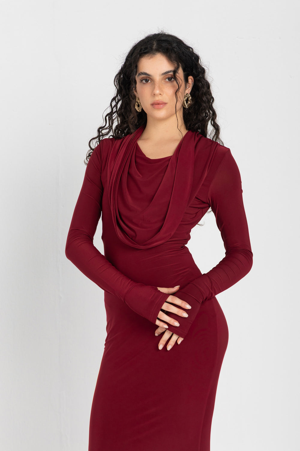 Woman wearing a burgundy dress against a white background