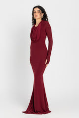Woman wearing a burgundy evening gown on a white background