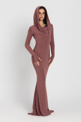 Woman wearing a long, cashmere dress with a hood on a white background