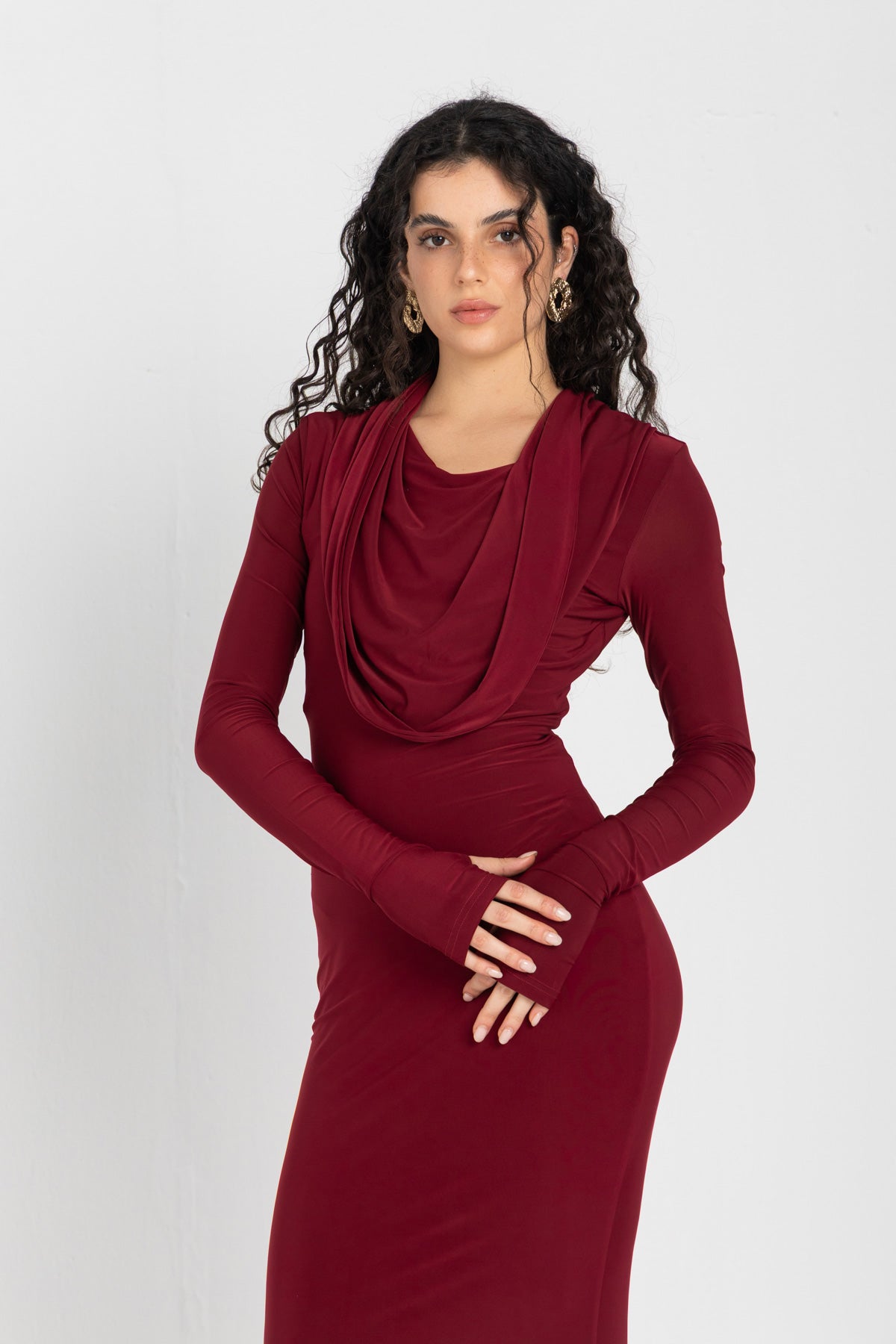 Woman wearing a burgundy dress against a white background
