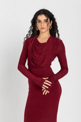 Woman wearing a burgundy dress against a white background