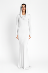 Woman wearing a long white dress with a hood on a white background